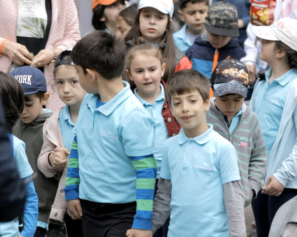 The children are in the yard of the church